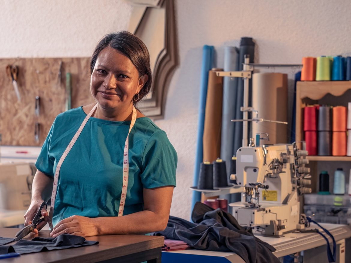 Portrait,Of,Mature,Latin,Woman,In,A,Sewing,Workshop.